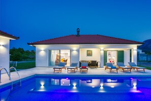 Night view of the property and the pool area perfect for summer nights