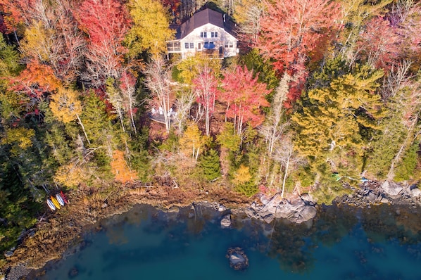 Drone view of water side of cottage.