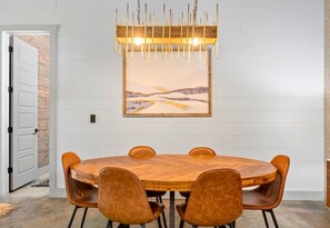 Savor your meals in an intimate setting, where modern lighting and rustic vibes meet.