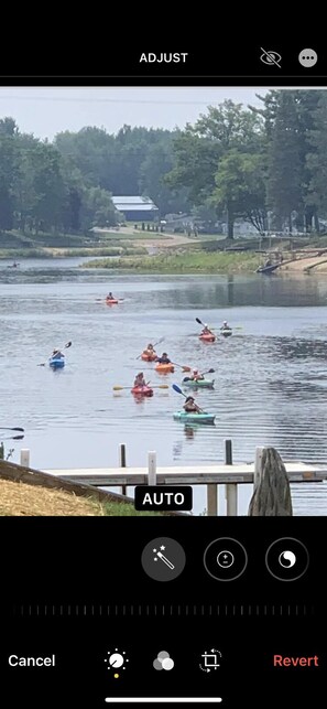 Kayaks on the water in front of the cabin.