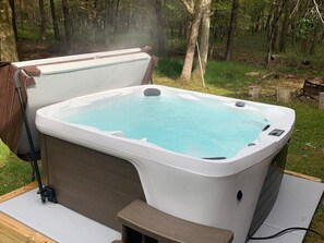 "Indulge in ultimate relaxation as you sink into the bubbling bliss of our spacious hot tub.  It's the perfect place for families to unwind and reconnect amidst the tranquil beauty of the Poconos. Immerse yourself in warm, soothing waters, let the stress melt away, and create unforgettable memories together