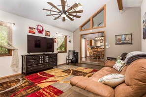 Our spacious family area, a perfect retreat for your Poconos getaway! Gather around the cozy fireplace and  enjoy a movie night on the 65-inch smart TV,. Create lasting memories as your family unwinds and bonds in this inviting space.