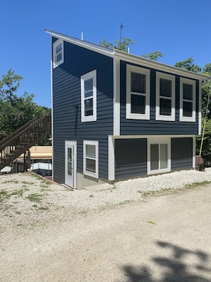 Street side of house with two parking spots to the left. 