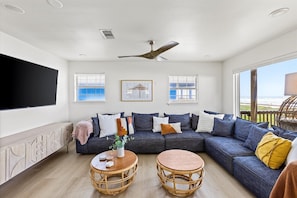 Open to the main living space is this massive and inviting sectional; every seat has a view of the 65" TV.