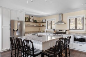 Oversized kitchen island for family meals and a centralized place to gather. 