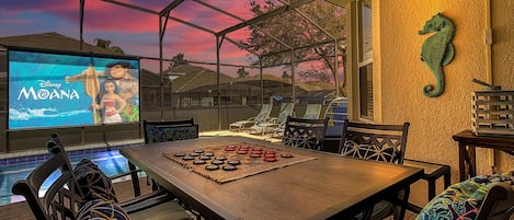 Welcome Home! Enjoy dinner or playing games poolside while watching a movie or sporting event on the 120" outdoor theatre!