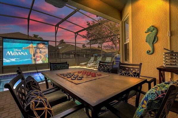 Welcome Home! Enjoy dinner or playing games poolside while watching a movie or sporting event on the 120" outdoor theatre!