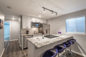 fully stocked kitchen with full-sized appliances. 