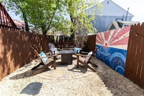 The home even has a private backyard patio with a fire pit and fenced-in yard.