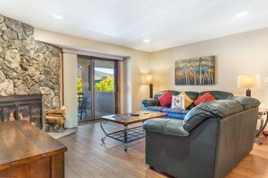The plush, living room couches and wood burning fireplace create the perfect spot to gather!