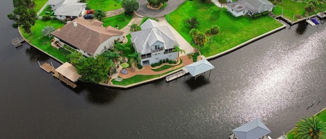 Waterfront home with dock on wide canal