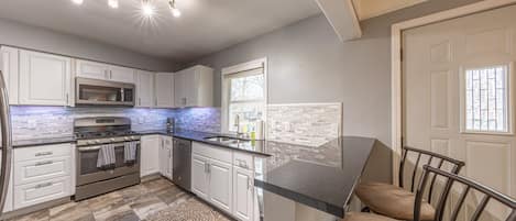 Large kitchen with SS appliances and granite counters