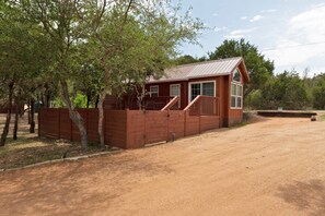 "The Bison" cabin with private parking space and fenced in yard and deck.