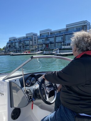 Joey Friday taking his guests for a boat tour of Friday Harbour and Lake Simcoe