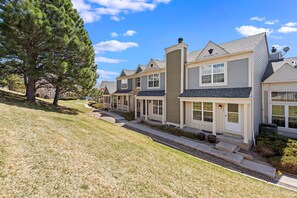 The front door opens to a grassy area and walk path 