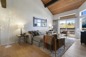 Living Room with Vaulted Wood Ceilings, a  Cozy Sofa and Flat Screen TV