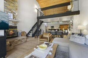 Living Room with Vaulted Wood Ceilings, a  Cozy Sofa and Flat Screen TV - Staircase leads to the Loft
