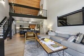 Living Room with Vaulted Wood Ceilings, a  Cozy Sofa and Flat Screen TV