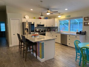 Large kitchen and living area opens to pool and screened lanai