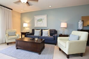 Comfortable living room with muted, tropical decor.
