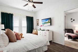 Open up the blinds and curtains in the primary bedroom and let the light in or close them to black out the light and sleep in.