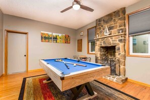 Step into our game area. The billiards table beckons, promising hours of friendly competition and lighthearted fun. The warmth of the propane fireplace adds a touch of cozy elegance, inviting you to unwind and savor every moment of your family getaway.