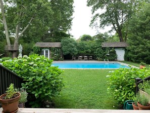 back porch view of pool and sheds