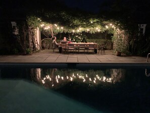 Outdoor dining table wonderfully lit at night
