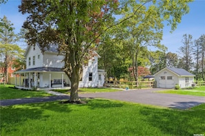 Farmhouse with wraparound porch, offstreet parking and private fenced rear yard.