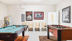 Fun-filled game room with pool, foosball, and classic decor—perfect for all ages!