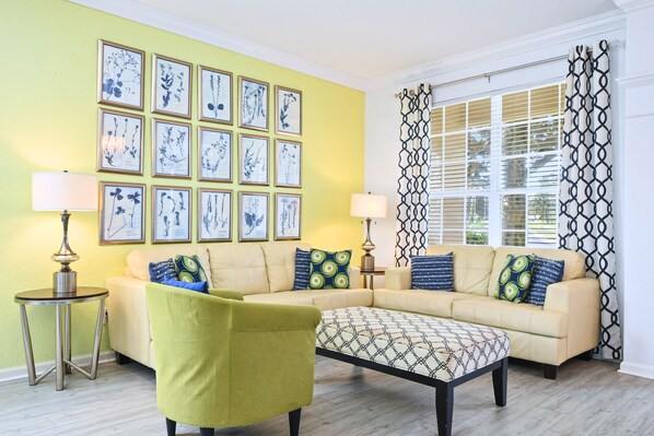 Bright, stylish living room with comfy seating, modern decor, and natural light.