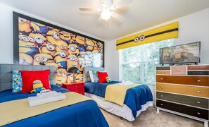 Fun Minions-themed twin room with bright decor, TV, and playful energy.