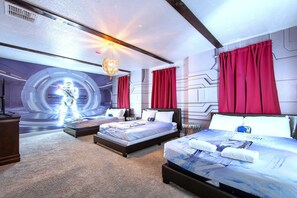 Spacious sci-fi room with space-themed beds, wall art, and room for the crew.
