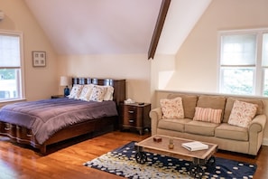 View of queen-sized bed and pull-out couch/sitting area