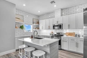 The kitchen is large and features plenty of supplies for cooking all your favorite family meals.