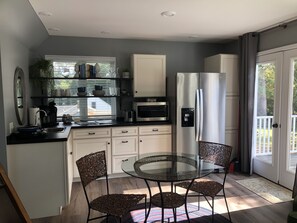 Efficiency kitchen with small dining area.  Added brand new full refrigerator.