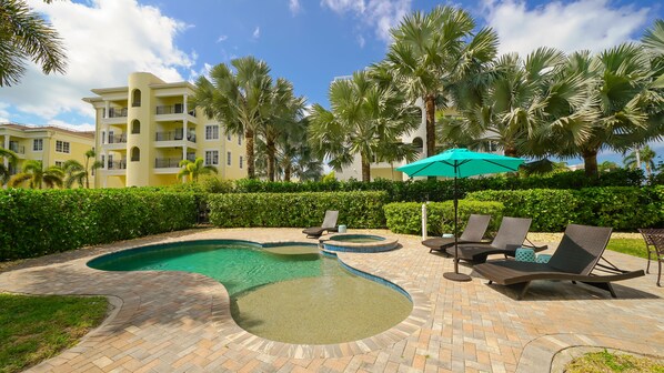 The pool with Baja shelf, hot tub, patio and chaise lounges for the ultimate relaxation!