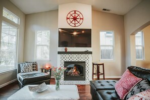 Relax by the cozy fireplace and unwind in a bright, stylish living space perfect for morning coffee or evening wine.