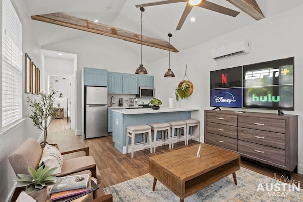 Living room with smart tv and full kitchen