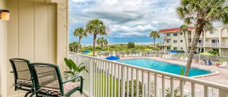 Enjoy a cup of coffee or glass of wine on the balcony overlooking the pool and beach!