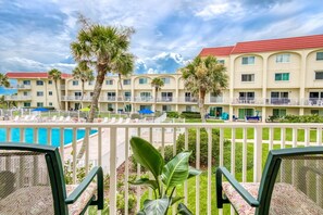 The balcony overlooks the pool and provides partial ocean views.