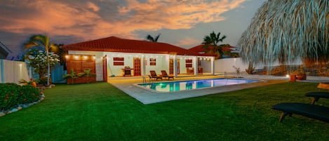 Attractive Lamp and pool area of the Villa in Noord, Aruba - Cosy beach chairs available - Amazingly designed pool with lighting in the lawn  of the villa - Refreshing Envoirnment - Beautiful planted boundaries