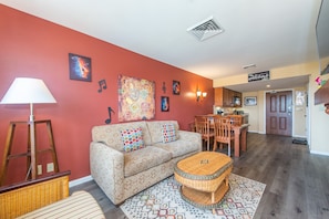 Vibrant colors, eclectic furnishings and fireplace - truly a one-of-a kind.