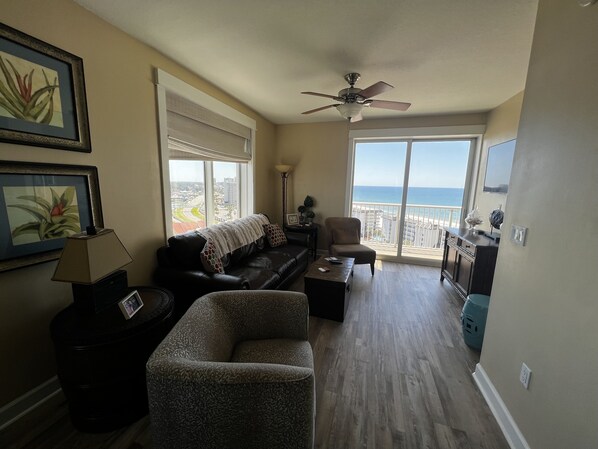 Great room with windows & access to balcony. 
