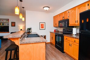 Full kitchen with dishwasher, disposal, microwave, fridge, toaster, and oven.