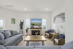 Cozy yet Spacious - Comfortable furnishings allow unimpeded views of three focal points in one – a large HDTV, gas fireplace, and windows with an ocean view.