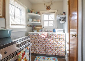 A vintage kitchenette, full size stove and oven, and good sized refrigerator.