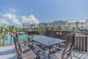 LARGE TERRACE FOR DINING AND LOUNGING.  VIEWS OF THE RESORT POOLS AND GULF OF MEXICO.