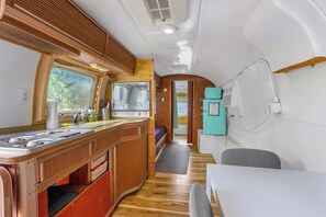 Kitchenette with sink, coffeemaker, refrigerator, microwave, and burner