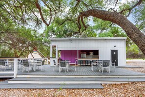 Outdoor kitchen and grill area with flat screen TV
